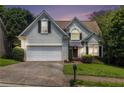 Charming two-story home with a well-maintained lawn, a two-car garage, and mature trees at 1469 Crescent Walk, Decatur, GA 30033
