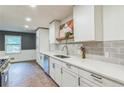 Bright kitchen featuring white cabinetry, stainless steel appliances, tile backsplash and white countertops at 364 Stafford Sw St, Marietta, GA 30064