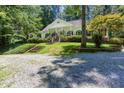 Beautiful home with a large front yard surrounded by mature trees at 5491 Hiram Rd, Powder Springs, GA 30127