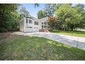 Beautifully landscaped front exterior with a driveway and two-car garage at 990 Trestle Dr, Austell, GA 30106