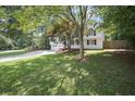 Traditional-style home with a manicured lawn and mature trees at 990 Trestle Dr, Austell, GA 30106