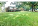 Beautifully landscaped front yard with lush green grass and mature trees at 2416 Timber Ridge Ct, Decatur, GA 30032