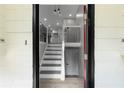Bright foyer with staircase; features neutral wall colors, updated flooring and modern lighting at 3267 Sunderland Dr, Snellville, GA 30039
