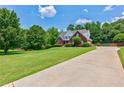 Beautiful home featuring a long driveway and lush green lawn at 4167 Alayna Lee Cir, Mcdonough, GA 30252