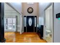 Bright foyer featuring a high ceiling, hardwood floors, and a modern design at 4167 Alayna Lee Cir, Mcdonough, GA 30252