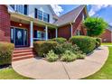 Inviting front porch with landscaped garden and covered entry at 4167 Alayna Lee Cir, Mcdonough, GA 30252