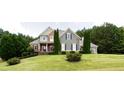 Attractive two-story home featuring lush landscaping and a well-manicured front yard at 240 Chandler Walk, Loganville, GA 30052