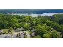 Stunning aerial view showcasing lush green trees, a serene lake, and the charming community at 4571 Academy St, Acworth, GA 30101