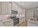 Beautiful kitchen featuring granite countertops, stainless steel appliances, and stylish white cabinetry at 4571 Academy St, Acworth, GA 30101