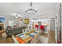 Open-concept living space with a dining area, kitchen, fireplace, and hardwood flooring at 4571 Academy St, Acworth, GA 30101