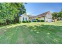 Charming ranch-style home with a well-kept lawn, mature trees, and a two-car garage at 2321 Sunnyview Ln, Dacula, GA 30019