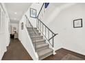 Elegant staircase with gray carpet, white walls, and stylish railing design at 12 Ivy Ne Rdg, Atlanta, GA 30342