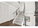 Elegant staircase with gray carpet, white walls, and stylish railing design at 12 Ivy Ne Rdg, Atlanta, GA 30342