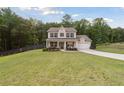 Beautiful two-story home with a covered front porch, attached garage, and expansive grassy front yard at 404 Arden, Ellenwood, GA 30294
