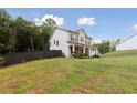 Charming two-story house featuring a covered porch, well-maintained lawn, and private yard at 404 Arden, Ellenwood, GA 30294