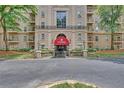 Elegant building entrance features a red awning and manicured landscaping for an inviting feel at 2865 Lenox Ne Rd # 103, Atlanta, GA 30324