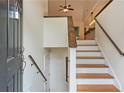 Bright foyer with wood staircase and banister leading to the upper level at 3372 English Oaks Nw Dr, Kennesaw, GA 30144