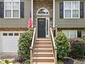 Close-up of the home's entryway featuring a classic front door and a welcoming staircase at 3372 English Oaks Nw Dr, Kennesaw, GA 30144