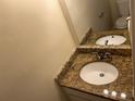 Bathroom featuring a double vanity with granite countertops and modern fixtures at 5040 Brittany Dr, Stone Mountain, GA 30083