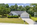 Charming single-story home featuring well-manicured lawn, complemented by mature trees and a two car garage at 706 Hillmont Dr, Loganville, GA 30052