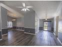 Expansive living room features hardwood floors, gray walls, and custom moulding at 706 Hillmont Dr, Loganville, GA 30052