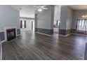 Spacious living room featuring luxury vinyl plank flooring, neutral tones and a fireplace at 706 Hillmont Dr, Loganville, GA 30052