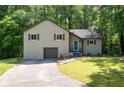 Two-story home featuring neutral siding, a front-entry garage and manicured front lawn at 880 Winfield Sw Ct, Marietta, GA 30060