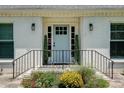 Close up of the home's entry showing a blue front door flanked by black sconces at 2936 Randolph Ne Rd, Atlanta, GA 30345