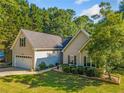 Inviting home with well-manicured lawn and landscaping, complete with attached two-car garage at 3540 Pilgrim Mill Rd, Cumming, GA 30041