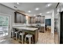 Well-lit kitchen with stainless steel appliances, granite countertops, and a breakfast bar with seating at 2625 Harbor Point Ct, Cumming, GA 30041