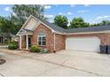 Brick home featuring a two-car garage and well-maintained landscaping at 3309 Raes Creek Rd # 13, Marietta, GA 30008