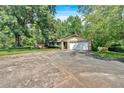 Charming single-story home with mature trees, lush lawn, two-car garage, and a brick and siding exterior at 4866 S Lilburn Stone Mountain Road Sw Rd, Lilburn, GA 30047