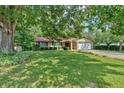 Charming single-story home with mature trees, lush lawn, two-car garage, and a brick and siding exterior at 4866 S Lilburn Stone Mountain Road Sw Rd, Lilburn, GA 30047