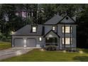 Charming two-story home with a two-car garage, black and white trim, and an evening sky at 6492 Swift Creek Road, Lithonia, GA 30058