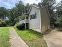 A view of the side of the home, highlighting the vinyl siding, driveway and two-car garage at 1 Thorntree Pass, Powder Springs, GA 30127