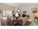 Bright living room featuring a fireplace, and traditional furniture arrangement at 10050 Lauren Hall Ct, Alpharetta, GA 30022