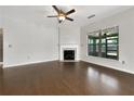 Bright living room with hardwood floors, fireplace, and large windows overlooking backyard at 2838 Menton Rd, Powder Springs, GA 30127