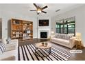 Beautifully staged living room with fireplace, built-in shelves, and plenty of natural light at 2838 Menton Rd, Powder Springs, GA 30127