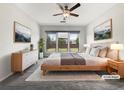 Comfortable main bedroom with large windows, ceiling fan, and neutral decor at 2838 Menton Rd, Powder Springs, GA 30127