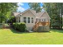 Lush backyard featuring a wooden deck that is great for entertaining and enjoying the outdoors at 15 Miners Pt Se, Acworth, GA 30102