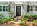 Charming front entrance with a black door, potted flowers, and manicured landscaping at 2136 N Landing Way, Marietta, GA 30066