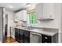 The bright kitchen features stainless steel appliances, updated counters and white cabinetry at 2136 N Landing Way, Marietta, GA 30066