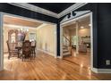 Open-concept living spaces featuring hardwood floors, a dining room, fireplace and stairway at 2695 Moon Cabin Dr, Powder Springs, GA 30127