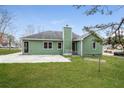 View of the house with a green lawn and a patio in the backyard at 2082 Blackberry Ln, Auburn, GA 30011