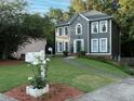 Two-story home with gray siding, white trim, a well-maintained lawn, and attractive landscaping at 4601 Gann Sw Xing, Smyrna, GA 30082