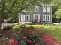 Beautiful two-story home with a well-manicured lawn and vibrant roses in the landscaped flowerbeds at 4601 Gann Sw Xing, Smyrna, GA 30082