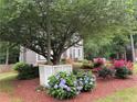 Landscaped yard with hydrangea and rose bushes enhancing the curb appeal of the home at 4601 Gann Sw Xing, Smyrna, GA 30082
