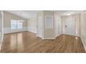 Bright foyer and dining room featuring hardwood floors, white trim, and a modern chandelier at 70 Prince Edward Way, Covington, GA 30016