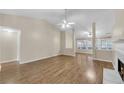 Spacious living room with hardwood floors, a fireplace, and plenty of natural light from the windows at 70 Prince Edward Way, Covington, GA 30016