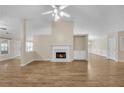 Spacious living room featuring hardwood floors, fireplace, and views to other rooms at 70 Prince Edward Way, Covington, GA 30016